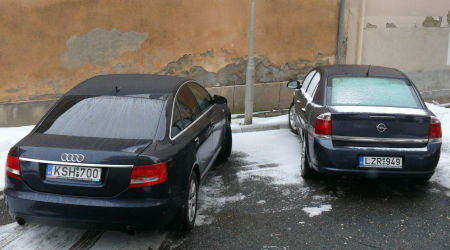 A polgármesteri Audi 6-os és a jegyzői Opel a városháza hátsó udvarán